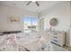 Bright bedroom with a white dresser, large window and beautiful decor, creating a cozy atmosphere at 14373 Shasta Daisy Pt, Parker, CO 80134