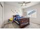 Inviting bedroom showcasing a cozy bed with decorative pillows and a window offering natural light at 14373 Shasta Daisy Pt, Parker, CO 80134