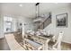 Bright dining room with modern chandelier and staircase, providing a welcoming space at 14373 Shasta Daisy Pt, Parker, CO 80134