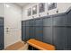 Welcoming entryway features a modern design with wainscoting, storage bench, and decorative wall art at 14373 Shasta Daisy Pt, Parker, CO 80134