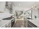 Sleek kitchen with white cabinets, modern appliances, and an adjacent dining area at 14373 Shasta Daisy Pt, Parker, CO 80134