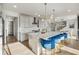 Contemporary kitchen with white cabinets, large island, and bar stools at 14373 Shasta Daisy Pt, Parker, CO 80134
