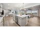 Modern open-concept kitchen with a large island, dining area, and living room at 14373 Shasta Daisy Pt, Parker, CO 80134