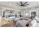 Spacious living room with plush sectional, hardwood floors, and open view to the kitchen area at 14373 Shasta Daisy Pt, Parker, CO 80134