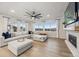Bright living room with a large sofa, fireplace, and scenic views from large windows at 14373 Shasta Daisy Pt, Parker, CO 80134