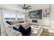 Inviting living room featuring a fireplace with tile surround and large windows offering scenic views at 14373 Shasta Daisy Pt, Parker, CO 80134