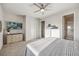 Relaxing main bedroom featuring a TV and closet, leading to the ensuite bathroom at 14373 Shasta Daisy Pt, Parker, CO 80134
