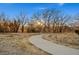View of community walking path through a natural setting with mature trees, grasses, and plants at 14373 Shasta Daisy Pt, Parker, CO 80134