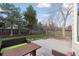 Private backyard with well-maintained lawn, mature trees, and outdoor seating area at 1534 Stanley Dr, Erie, CO 80516