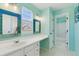 Bathroom features vanity space, double mirrors and access to tub and shower at 1534 Stanley Dr, Erie, CO 80516