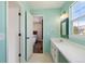Bathroom features vanity space, designer mirrors and view into a bedroom at 1534 Stanley Dr, Erie, CO 80516