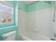 Bathroom interior featuring a tub and shower combination with modern fixtures and natural light at 1534 Stanley Dr, Erie, CO 80516
