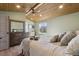 Inviting bedroom with a wood-paneled ceiling, modern fan, and comfortable bed with accent pillows at 1534 Stanley Dr, Erie, CO 80516