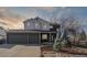 Beautiful home with a large three-car garage and well-maintained landscaping, including a small spruce tree and rock garden at 1534 Stanley Dr, Erie, CO 80516