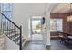Welcoming foyer featuring hardwood floors, staircase, and natural light at 1534 Stanley Dr, Erie, CO 80516