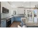 Well-appointed kitchen with two-tone cabinets, modern appliances, stainless steel sink, and large windows at 1534 Stanley Dr, Erie, CO 80516