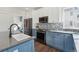 Modern kitchen with stainless steel appliances, blue cabinets and a beautiful tile backsplash at 1534 Stanley Dr, Erie, CO 80516