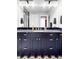 Elegant bathroom vanity with dark cabinets, gold hardware, and marble countertop at 6037 N Netherland Ct, Aurora, CO 80019