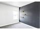 Modern bedroom with a gray accent wall, shelving and a large window at 6037 N Netherland Ct, Aurora, CO 80019