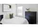 Bedroom with a neutral palette, framed art, and a large window for ample light at 6037 N Netherland Ct, Aurora, CO 80019