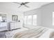 Airy bedroom features a ceiling fan, dresser, and a view from three large windows at 6037 N Netherland Ct, Aurora, CO 80019