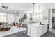 Open-concept living area featuring modern flooring, a staircase, and a dining area at 6037 N Netherland Ct, Aurora, CO 80019