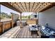 Inviting outdoor patio with a pergola, hot tub, and comfortable seating area at 6037 N Netherland Ct, Aurora, CO 80019