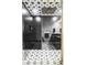 Modern shower with black tile, glass enclosure, a bench and star patterned floor and ceiling tiles at 6037 N Netherland Ct, Aurora, CO 80019