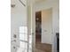 Bathroom showcasing white tiled shower, chrome fixtures, and open doorway at 18824 Robins Dr, Denver, CO 80249