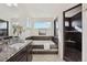 Modern bathroom with a soaking tub, black tile shower, and a double sink at 18824 Robins Dr, Denver, CO 80249