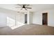 Spacious bedroom with plush carpeting, ceiling fan, and ample natural light at 18824 Robins Dr, Denver, CO 80249