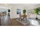 Bright dining area with a modern table, comfortable chairs, and a decorative rug at 18824 Robins Dr, Denver, CO 80249