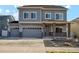 Charming two-story home with a three car garage and a beautifully landscaped front yard at 18824 Robins Dr, Denver, CO 80249