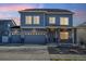 Charming two-story home with a three-car garage and inviting front porch at 18824 Robins Dr, Denver, CO 80249