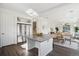 Open kitchen flows into the dining and living area, featuring a large island and modern appliances at 18824 Robins Dr, Denver, CO 80249
