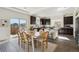 Eat-in kitchen with island, dark cabinetry, and modern appliances, and adjacent dining area at 18824 Robins Dr, Denver, CO 80249