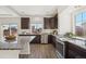 Well-lit kitchen featuring granite countertops, stainless steel appliances, and dark cabinetry at 18824 Robins Dr, Denver, CO 80249