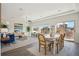 Spacious dining area connecting to a living room with large windows and stylish decor at 18824 Robins Dr, Denver, CO 80249