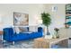 Comfortable living room with stylish blue sofa, contemporary artwork, and modern decor at 18824 Robins Dr, Denver, CO 80249
