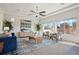 Bright living room features a ceiling fan, large windows, and stylish decor at 18824 Robins Dr, Denver, CO 80249