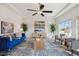 Spacious living room with tray ceilings, ceiling fan, stylish decor, and plenty of natural light at 18824 Robins Dr, Denver, CO 80249