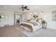 Bright main bedroom with plush carpet, lots of light and a decorative ceiling fan at 18824 Robins Dr, Denver, CO 80249