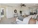 Main bedroom with bright light, a decorative ceiling fan, and access to the bathroom at 18824 Robins Dr, Denver, CO 80249