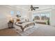 Sunlit main bedroom features multiple windows, a ceiling fan and neutral tones at 18824 Robins Dr, Denver, CO 80249