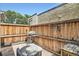 Private backyard patio with brick pavers, wooden fence, a grill, and space for outdoor seating at 2564 N Emerson St, Denver, CO 80205