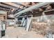 Unfinished basement with exposed pipes and concrete walls, offering potential for customization at 2564 N Emerson St, Denver, CO 80205