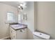 Cozy bathroom with granite countertop, white cabinetry, and decorative vanity lighting at 2564 N Emerson St, Denver, CO 80205