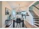 Inviting dining area with modern furniture, decor, and open flow to kitchen and staircase at 2564 N Emerson St, Denver, CO 80205