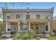 Charming grey brick duplex with a well-maintained lawn and covered front porches at 2564 N Emerson St, Denver, CO 80205