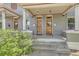 Inviting duplex entrances with classic doors, covered porches, brick columns, and manicured landscaping at 2564 N Emerson St, Denver, CO 80205
